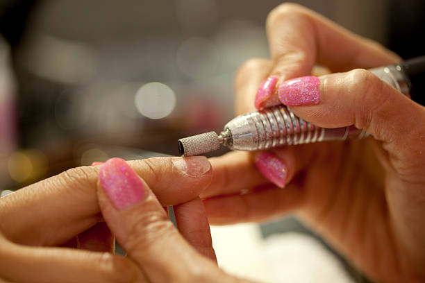 Getting nails filed at a nail salon